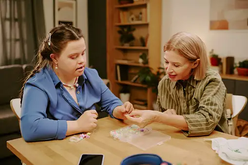 Person receiving community-based support doing arts and crafts